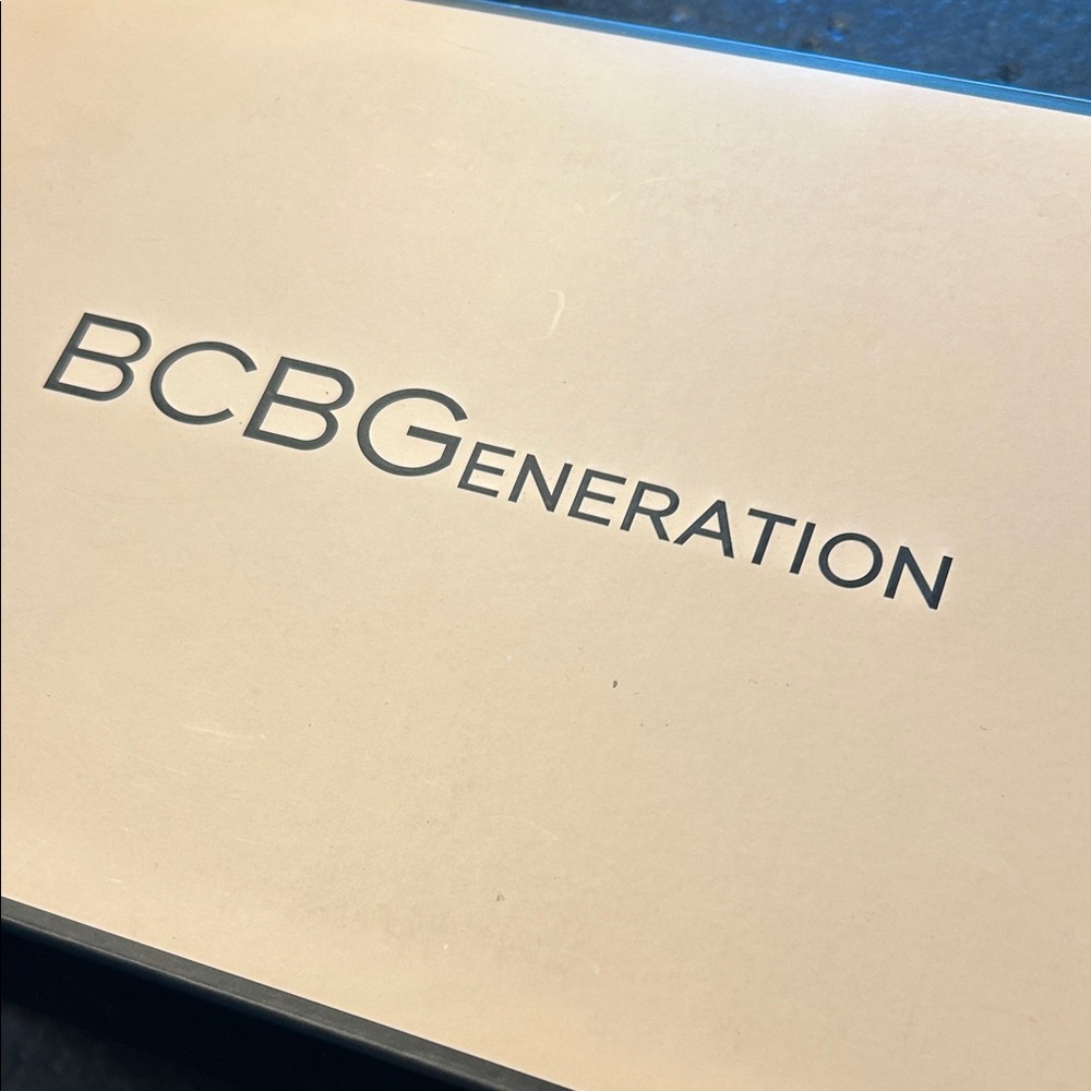 BCBGeneration Cream Packaging black sandals with silver rhinestones.